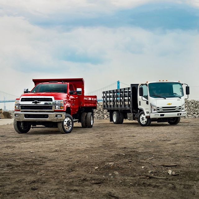 Two Chevy commercial vehicles sitting on a lot in Miami, Florida