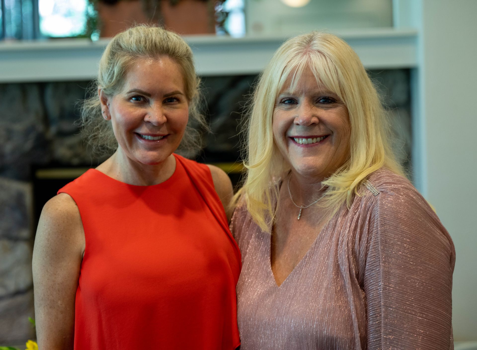 Kim Silverman and a women are posing for a picture together and smiling for the camera.