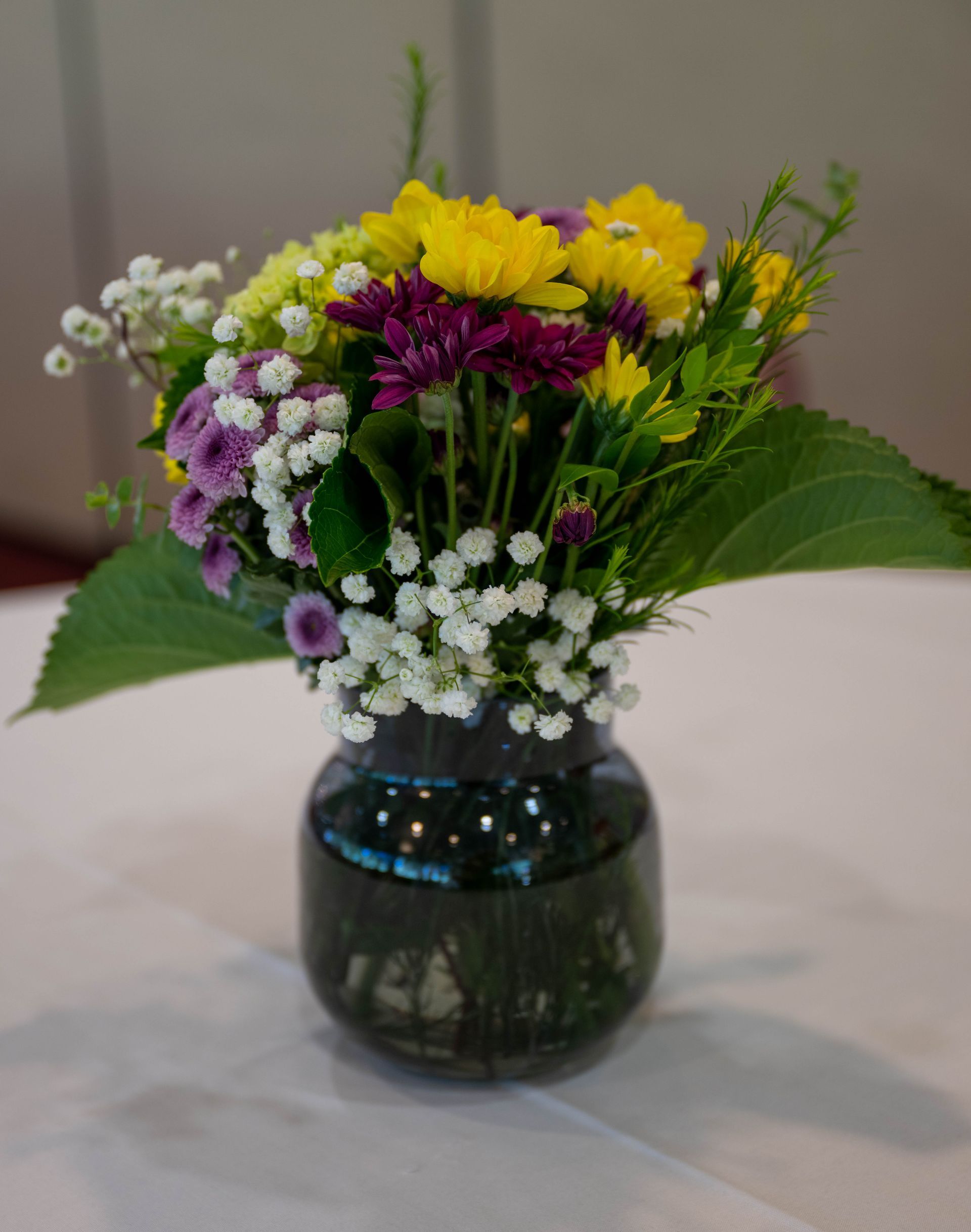 A vase filled with flowers is sitting on a table.