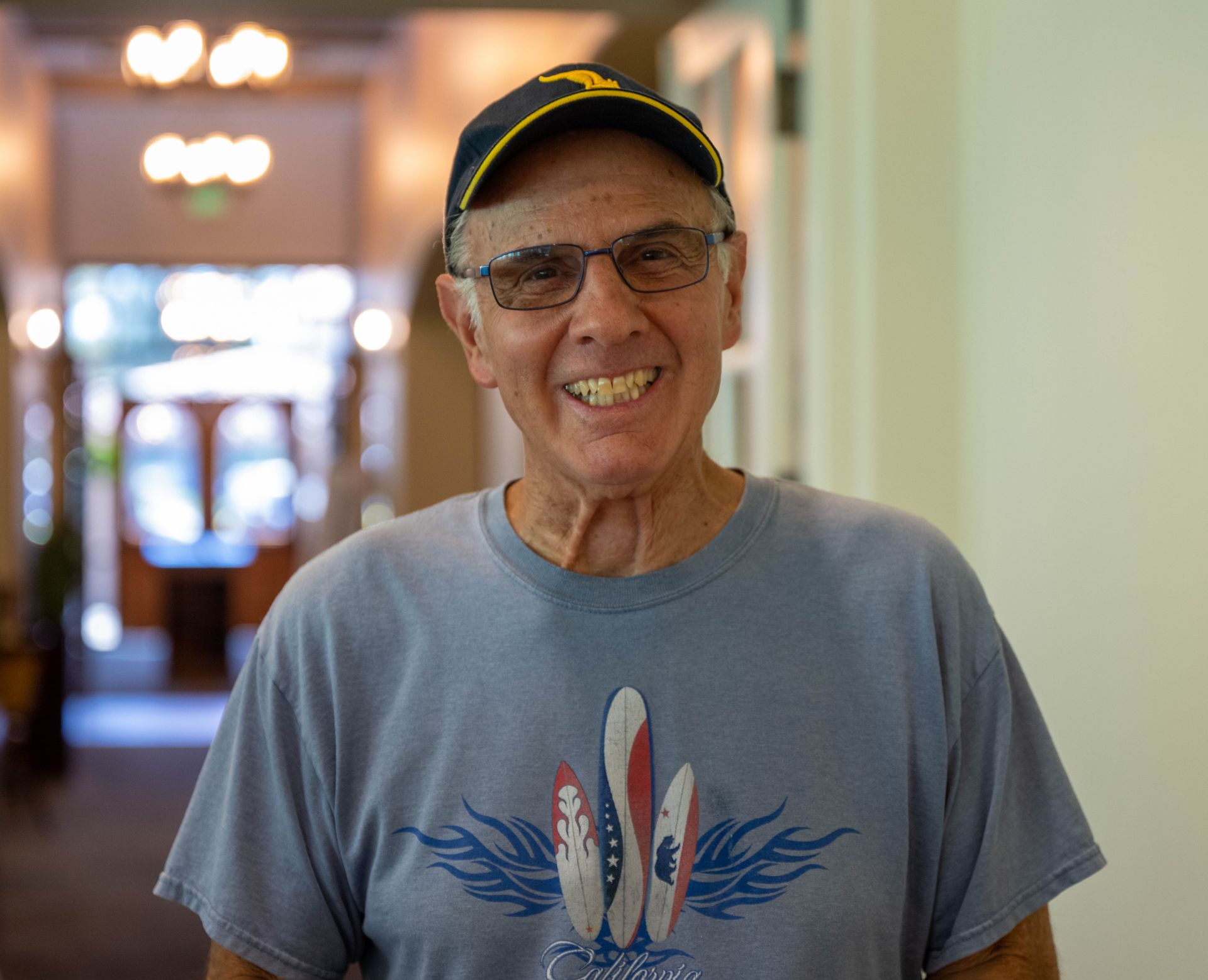 A man wearing a blue shirt with surfboards on it