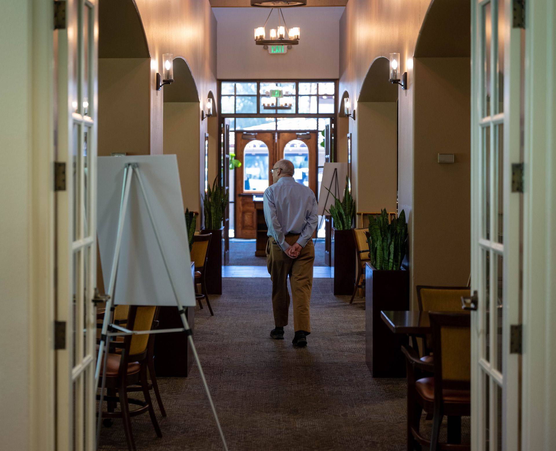 A man is walking down a hallway in a building