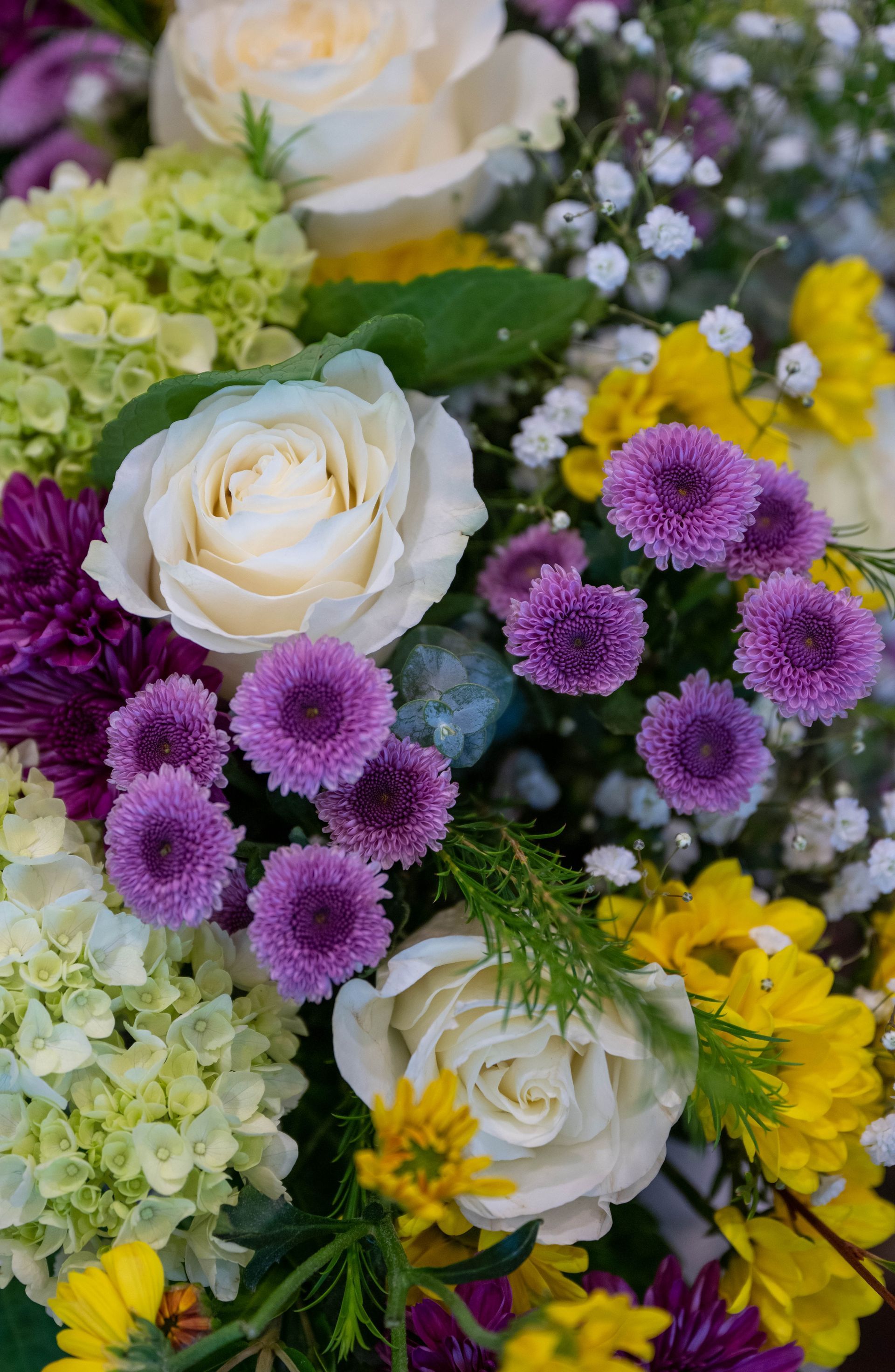 There are many different types of flowers in this bouquet.