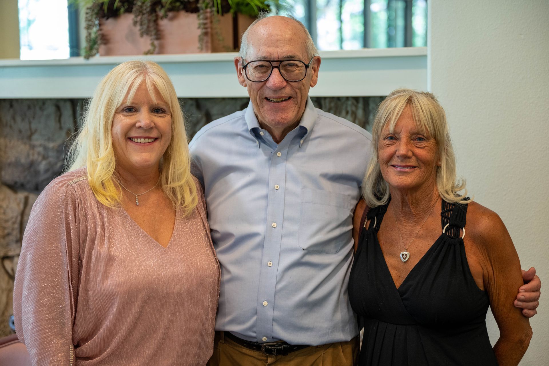 A man and women are posing with Kim Silverman for a picture together.