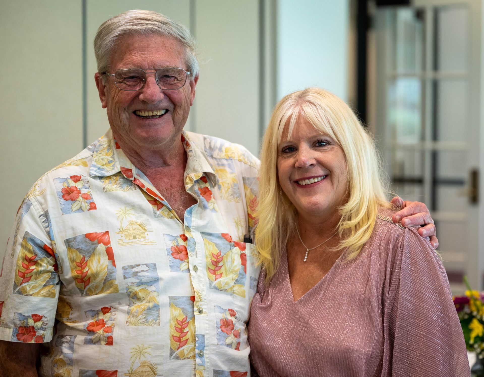 A man and Kim Silverman are posing for a picture together and smiling.