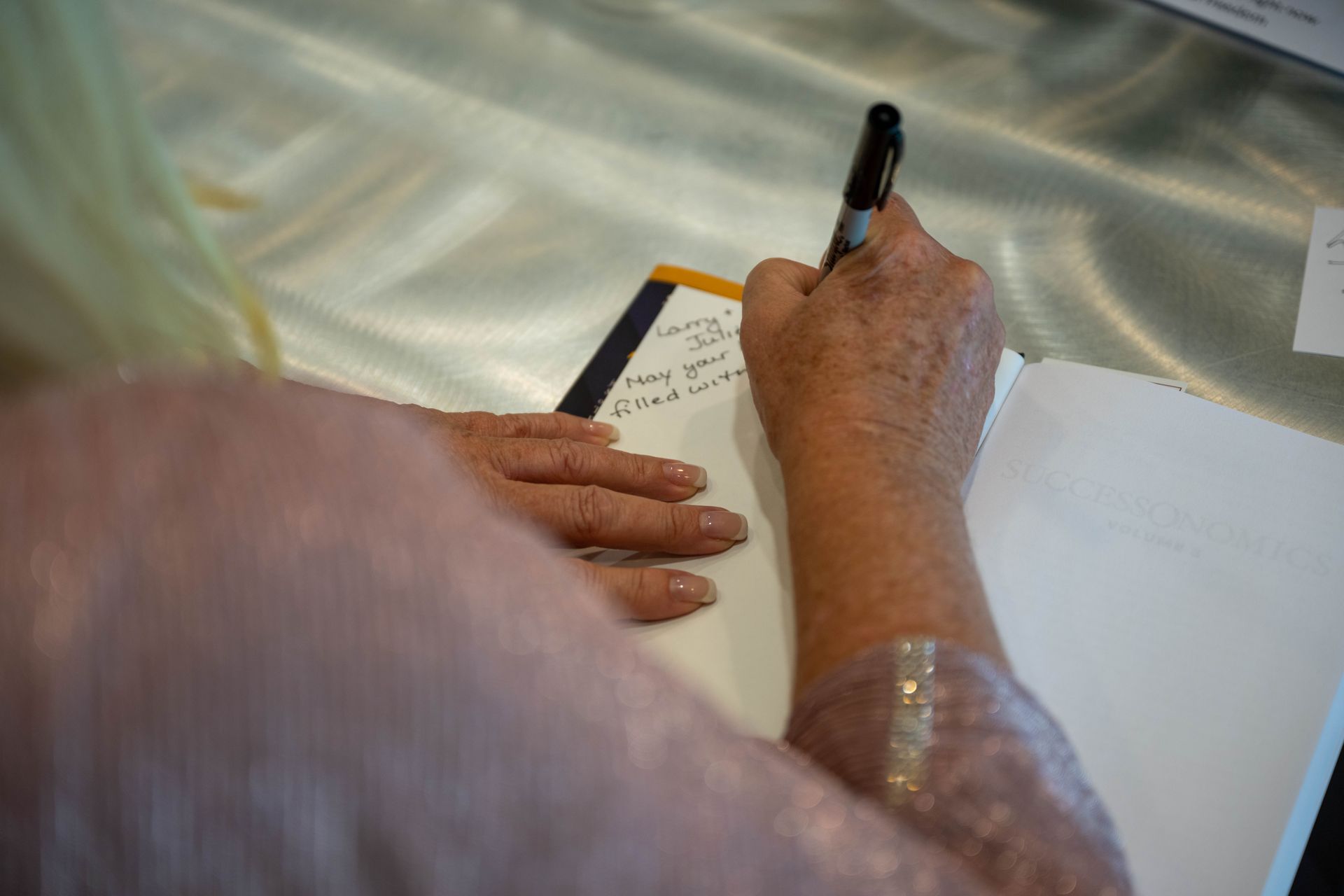 Kim Silverman is autographing a SuccessOnomics book.