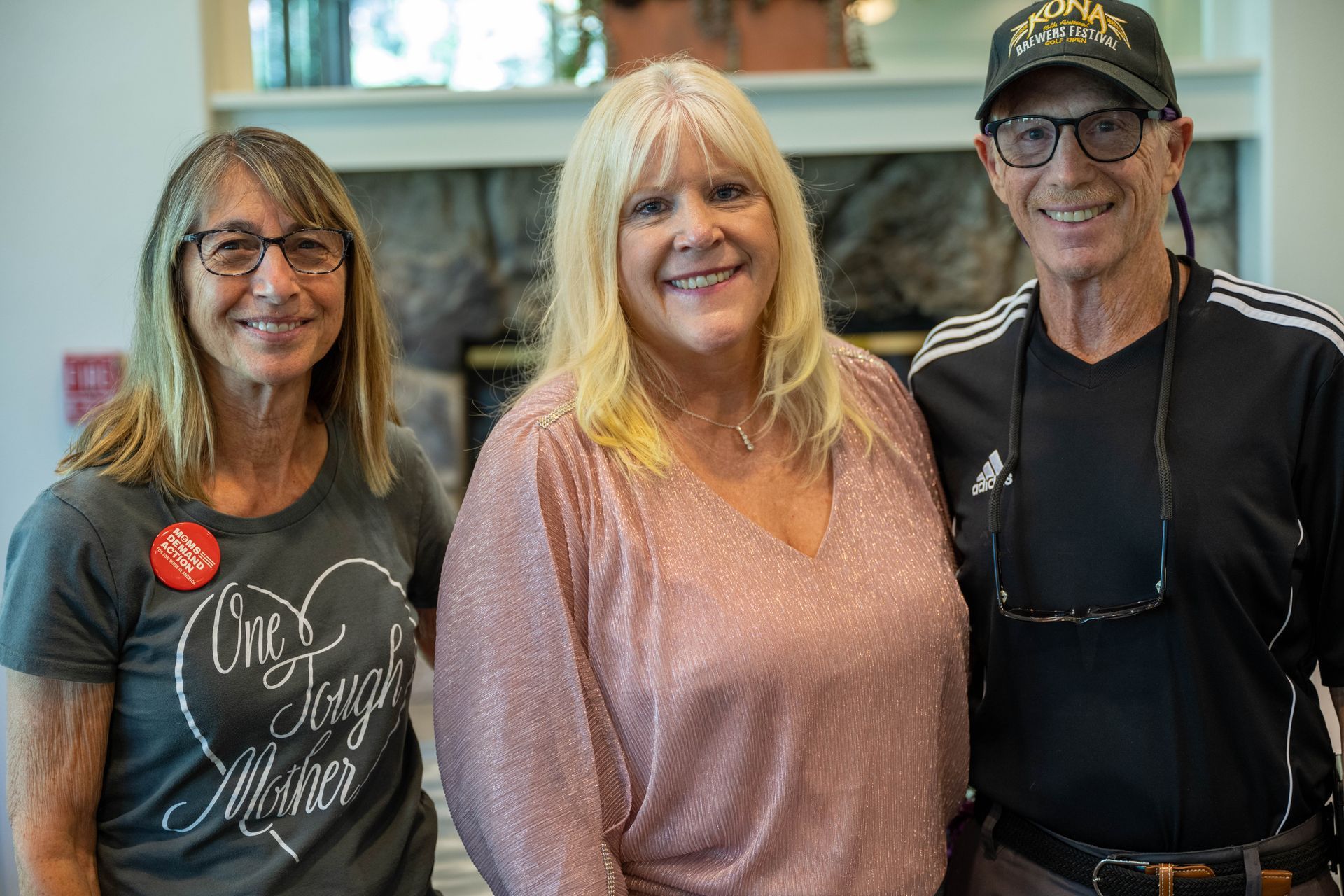 Kim Silverman with a man and women are posing for a picture together.