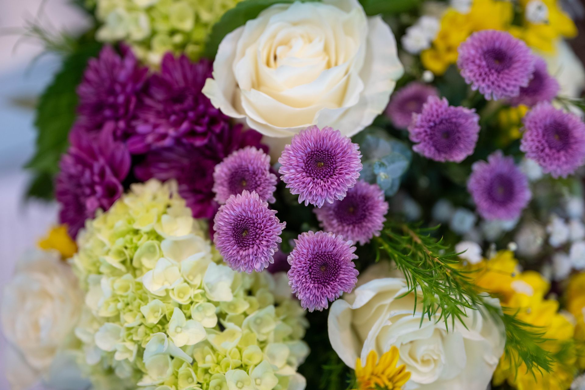 There are many different types of flowers in this bouquet.