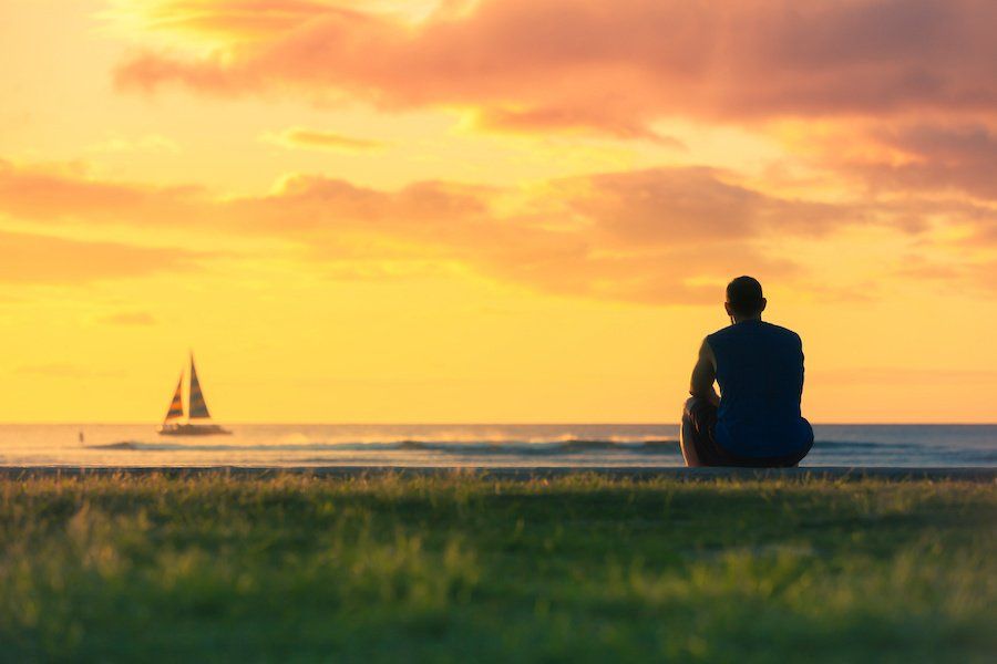 man watching far away at sunset