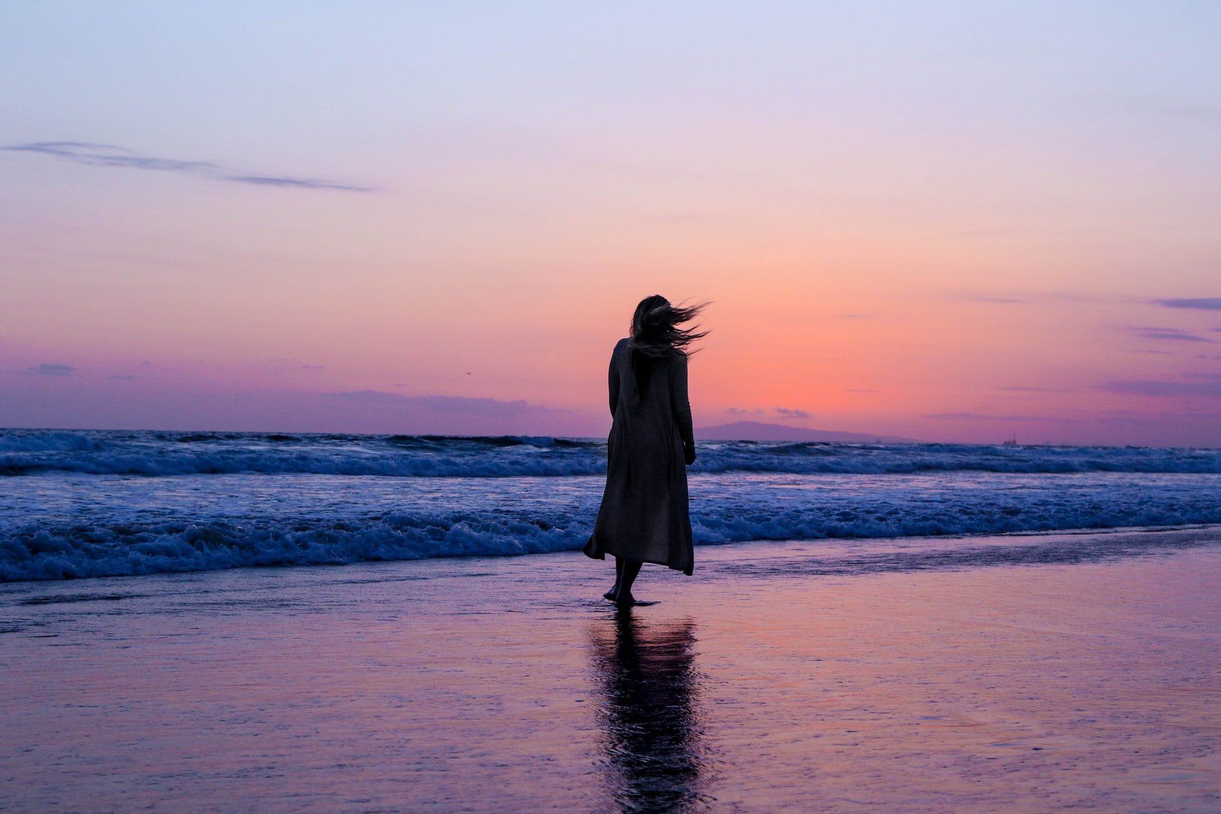 lady walking along the beach