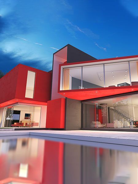 A red house with a lot of windows and a pool in front of it.