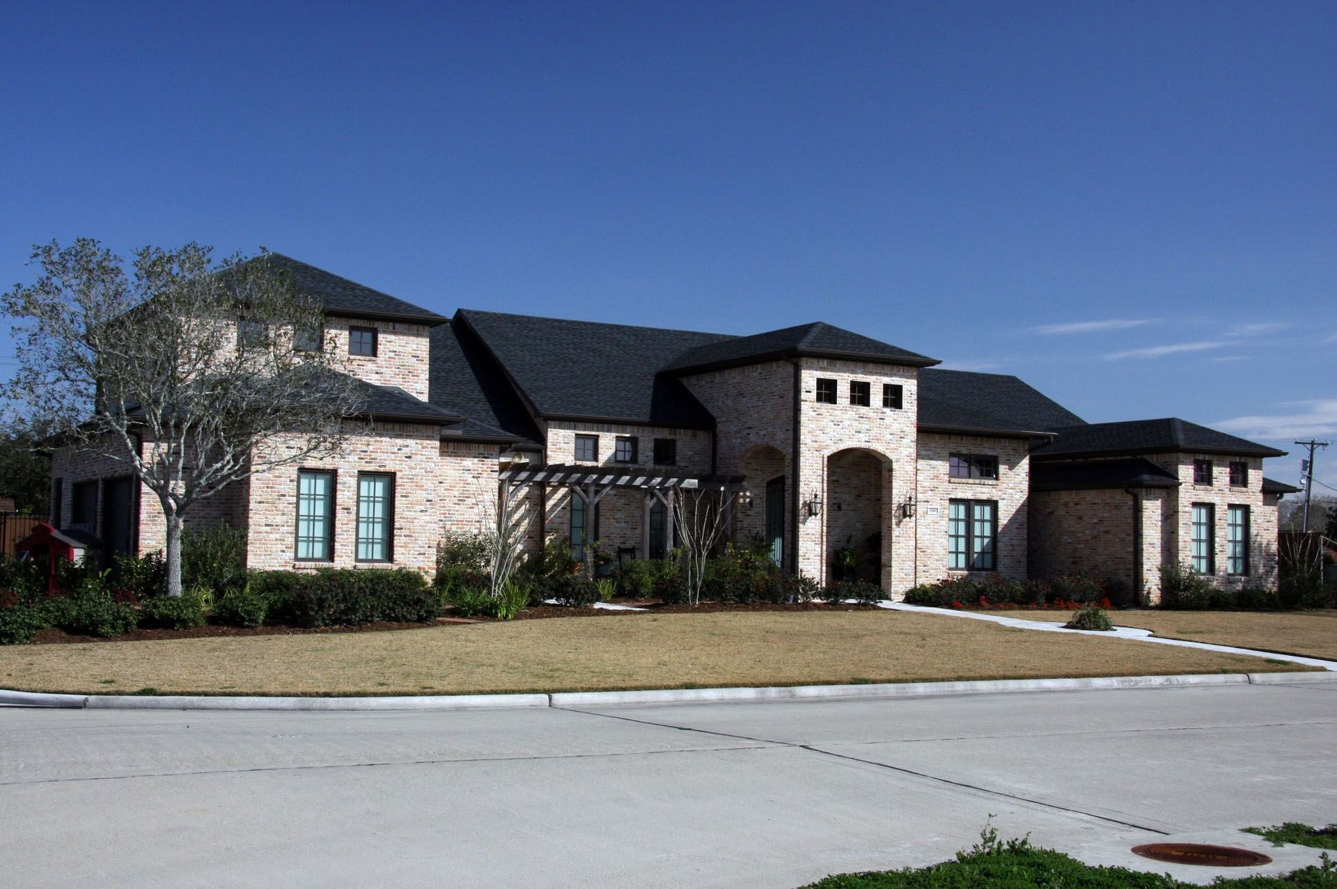 A large brick house with a black roof.
