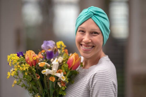 A woman with cancer holds a beautiful bouquet of flowers - Guyton, GA - Pendleton Financial Group