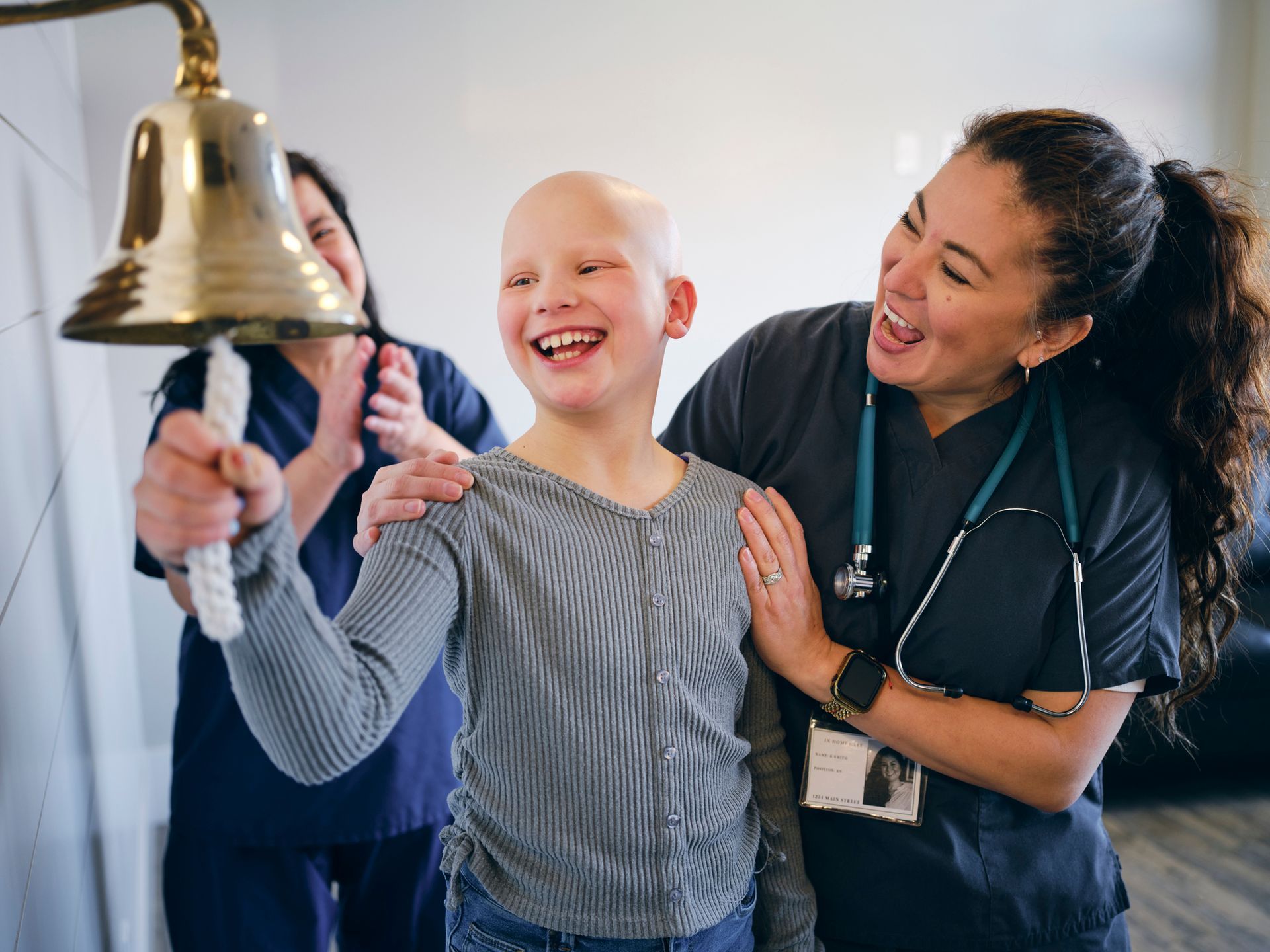 A child rings a bell as she celebrates the end of her chemotherapy treatment - Guyton, GA - Pendleton Financial Group