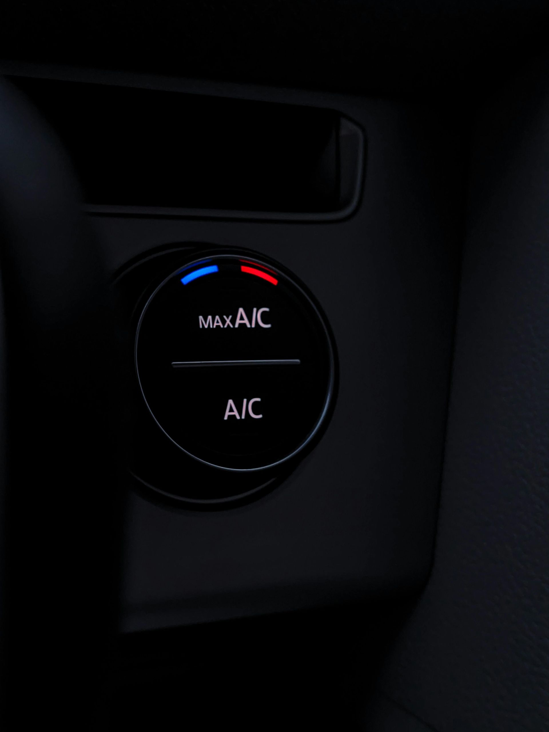 A close up of a button that says max a/c and a/c