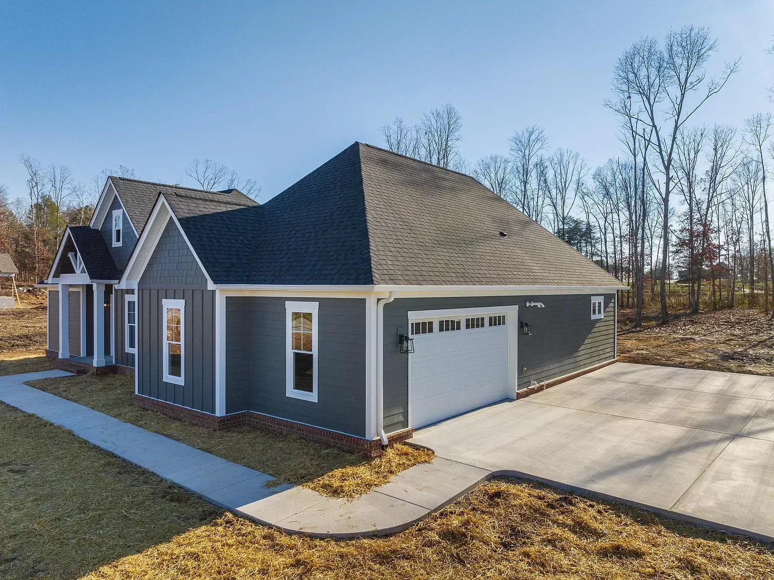 a gray house with a white garage door