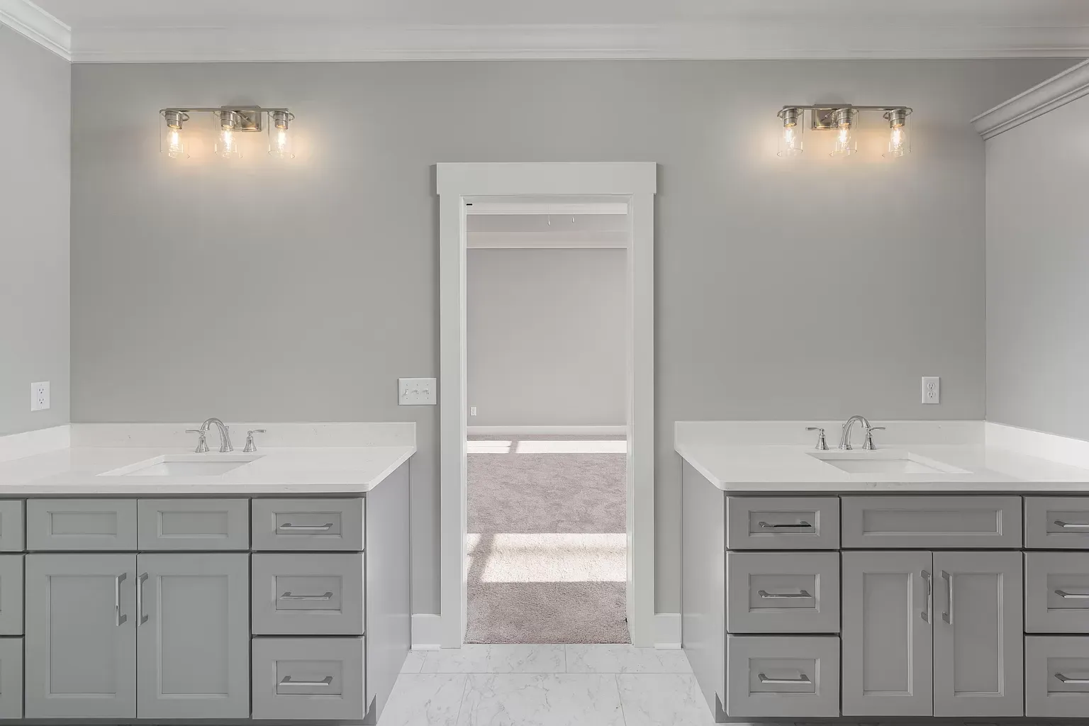 a bathroom with two sinks and a mirror