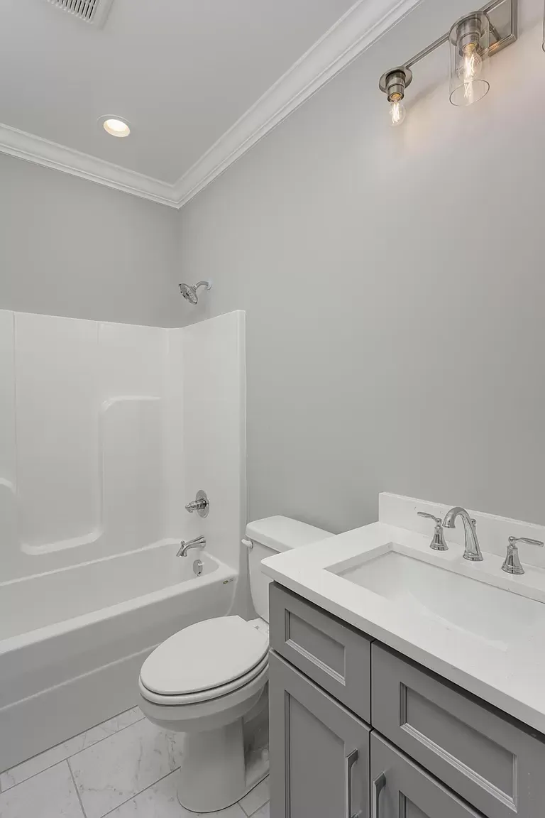 a bathroom with a toilet a sink and a bathtub