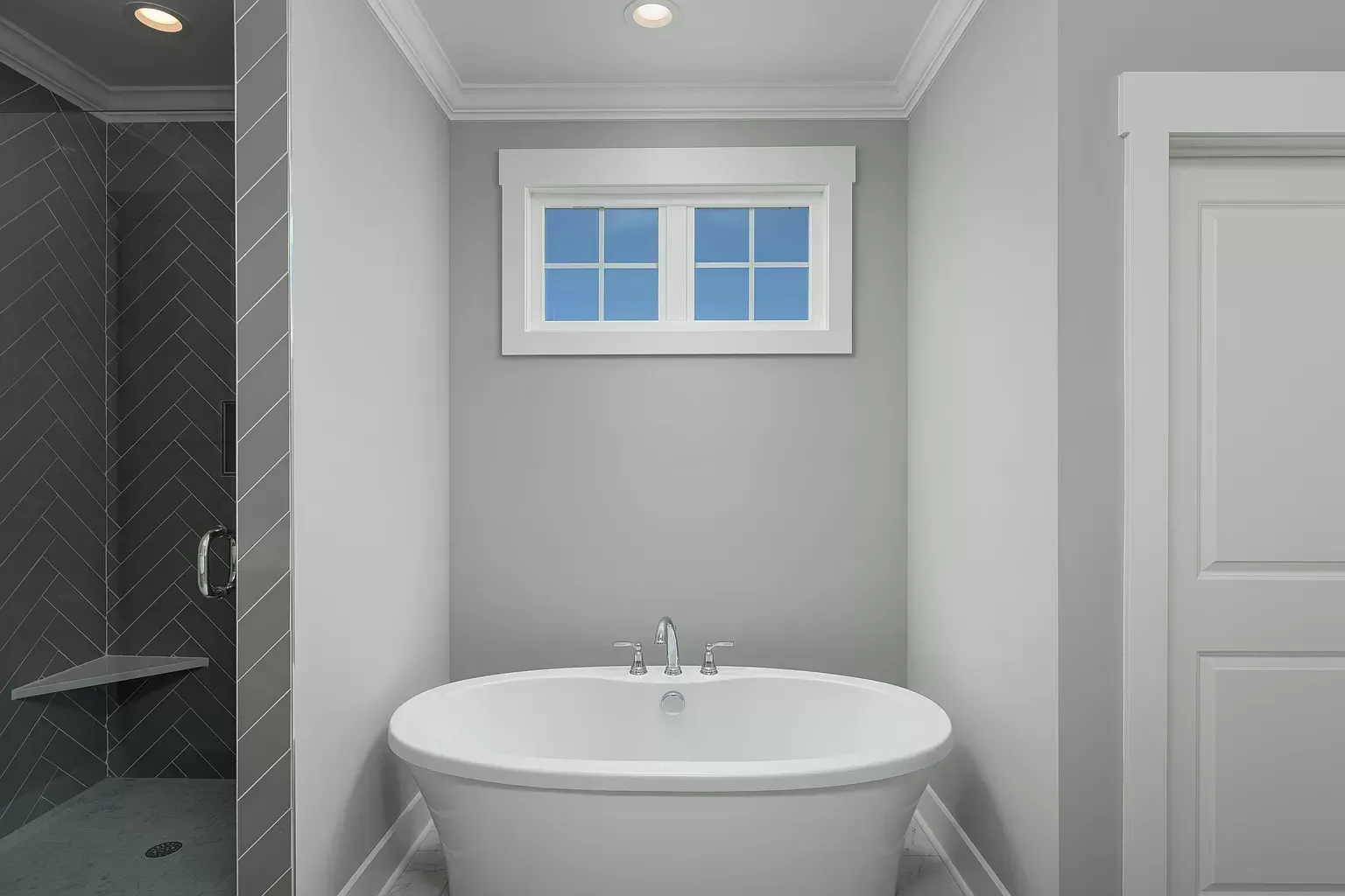 a bathtub in a bathroom with a window above it