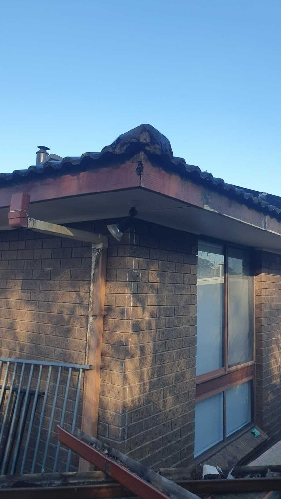 Brick Building Corner With Brown Roof — The Roofer Troopers (NSW) in Howlong, NSW