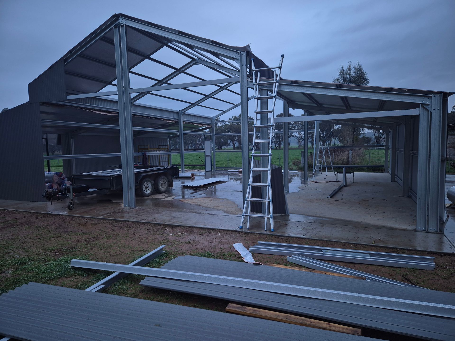 Metal frame building under construction with a ladder. — The Roofer Troopers (NSW) in Rutherglen, VIC