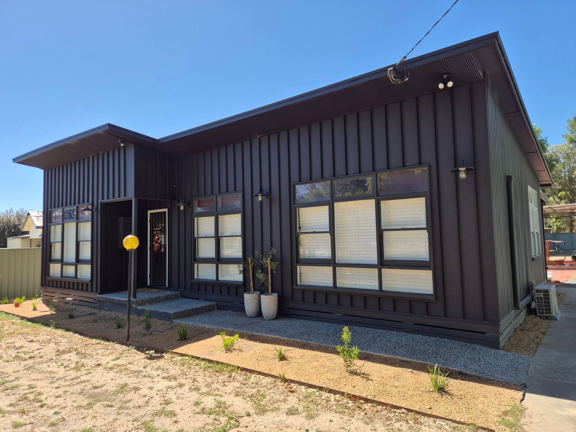 Modern Black Single-story House With Large Windows — The Roofer Troopers in Wodonga, VIC