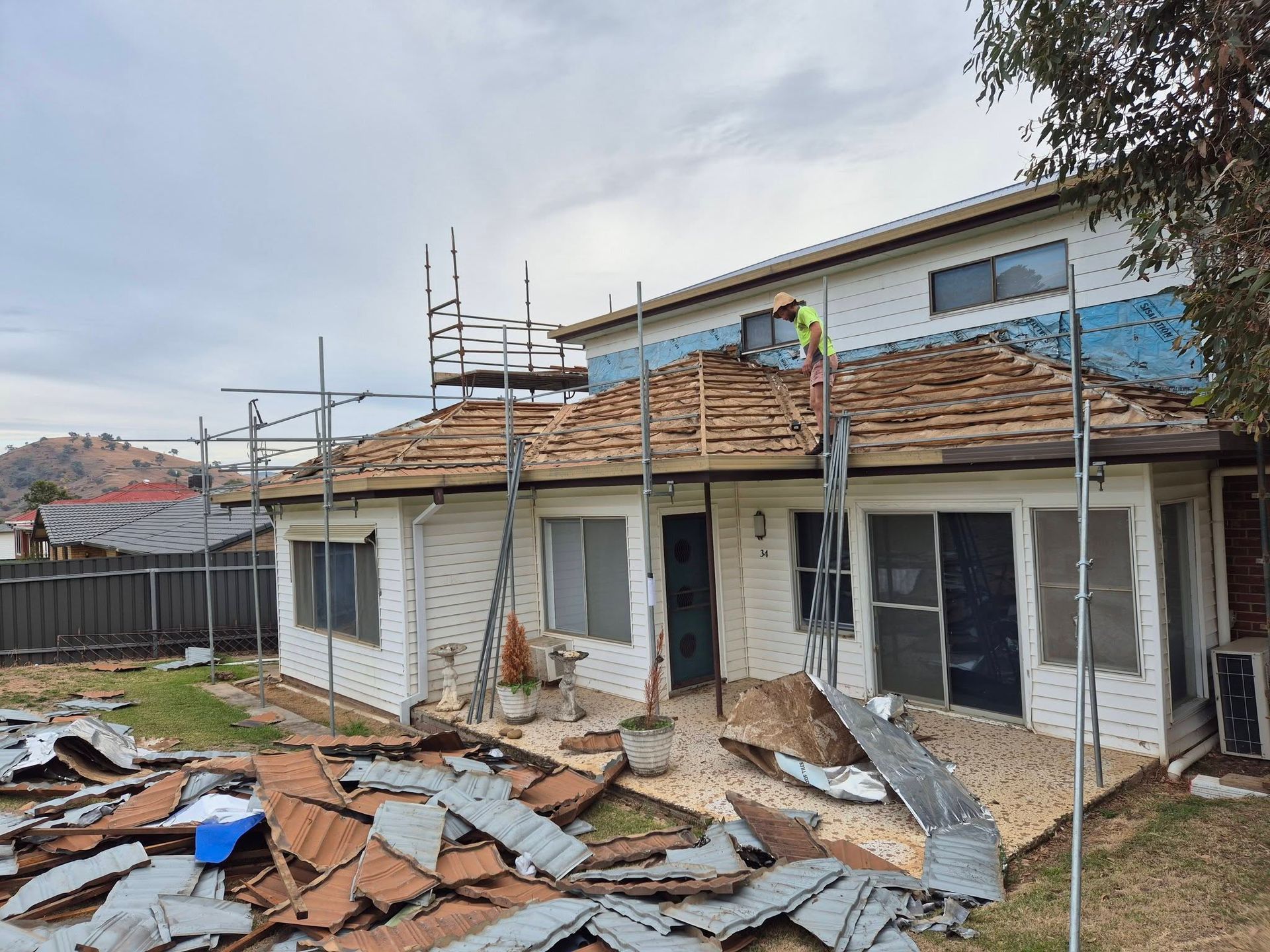 Partially Demolished House With Debris Scattered in the Yard — The Roofer Troopers in Wodonga, VIC