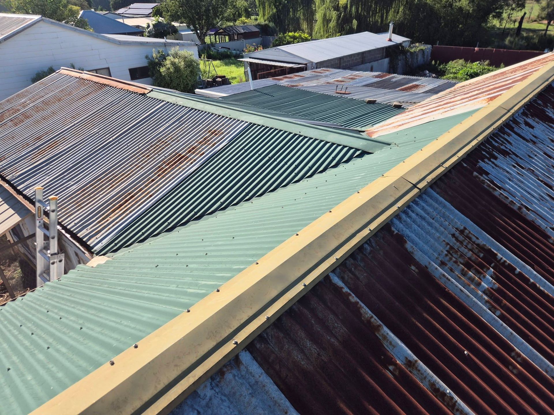 Aerial View of Rusted and Green Corrugated Metal Roofs — The Roofer Troopers in Wodonga, VIC
