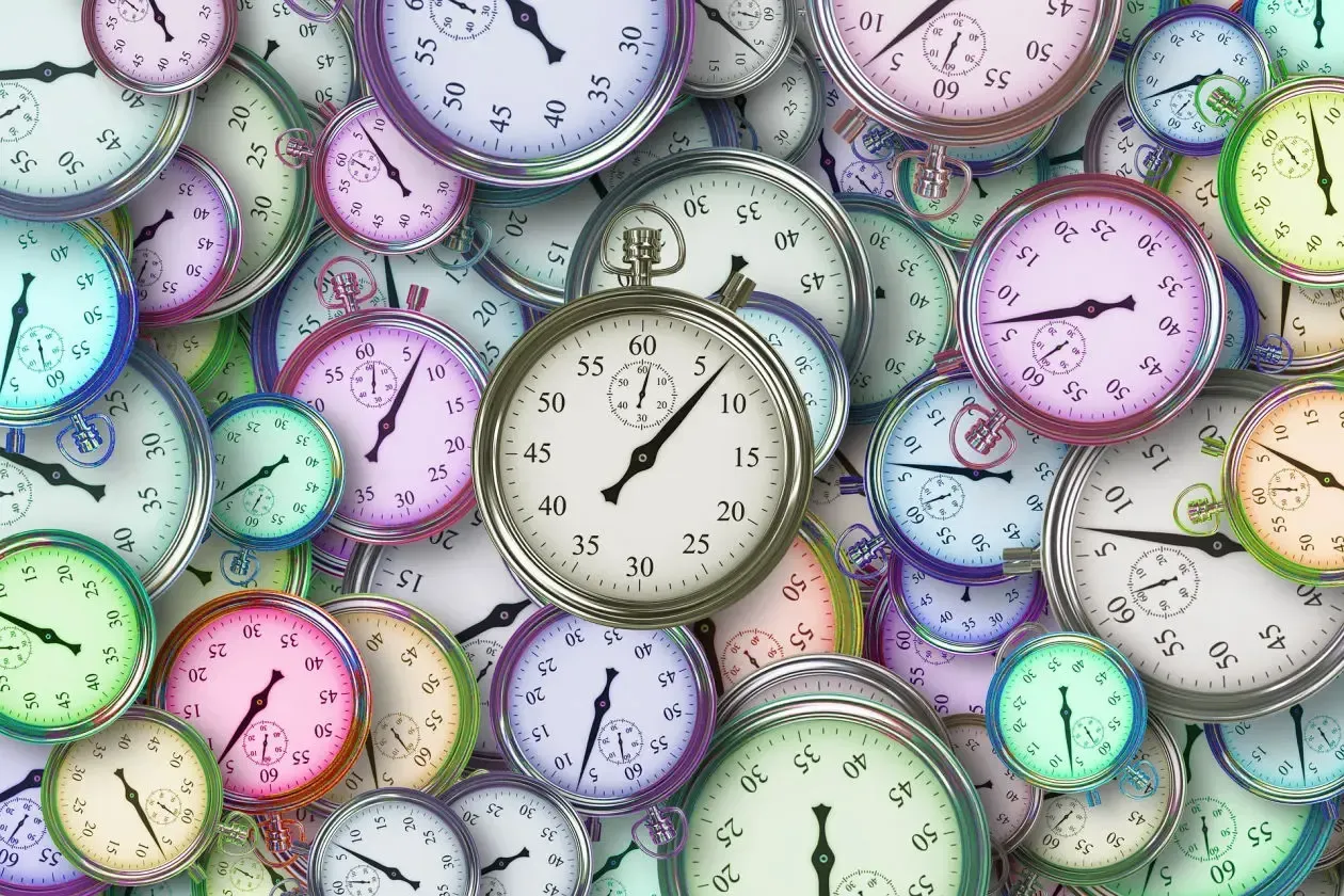 A bunch of colorful clocks are stacked on top of each other