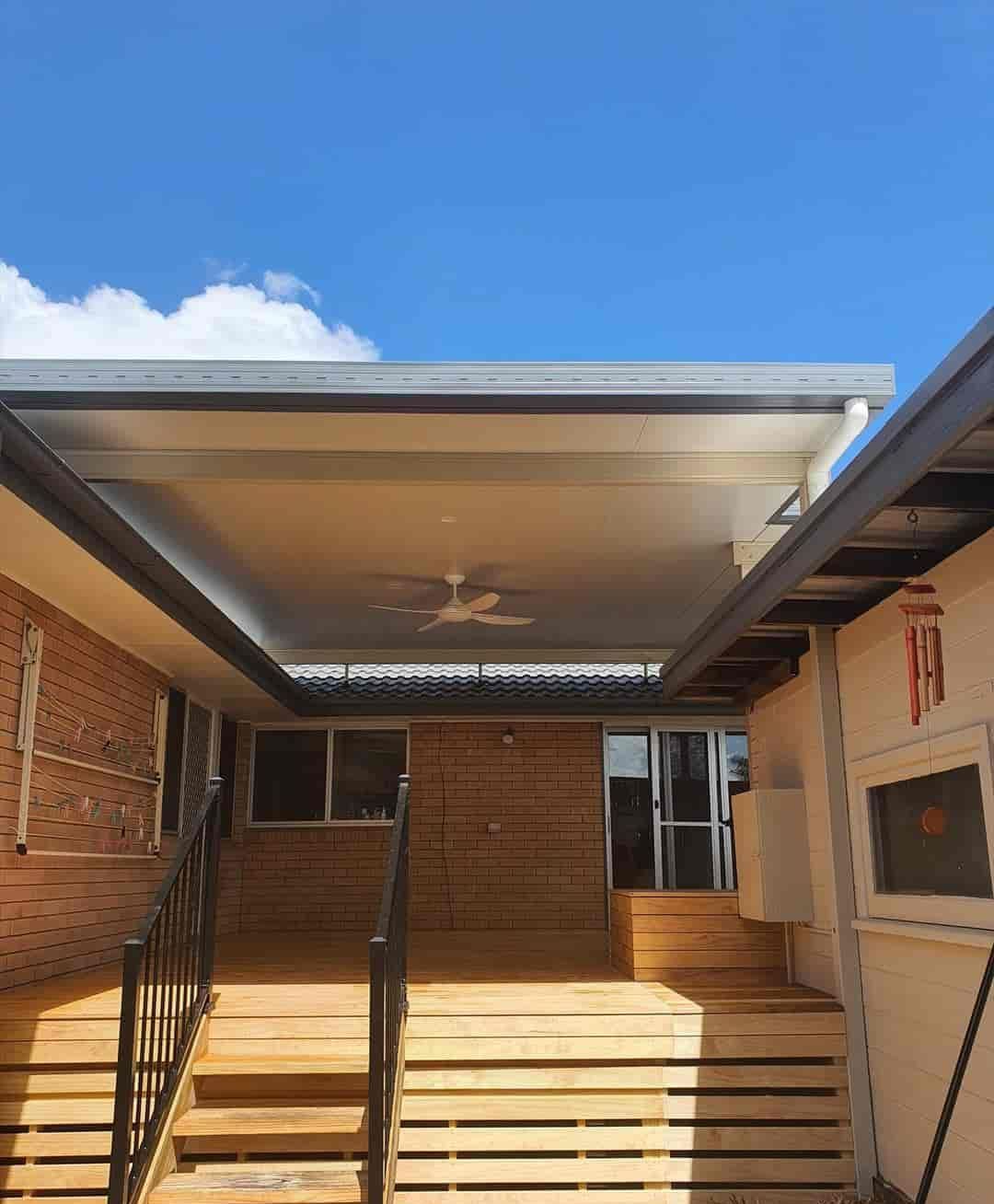 A House With A Wooden Deck And Stairs Leading To It — Caprice Home Additions In Taree, NSW