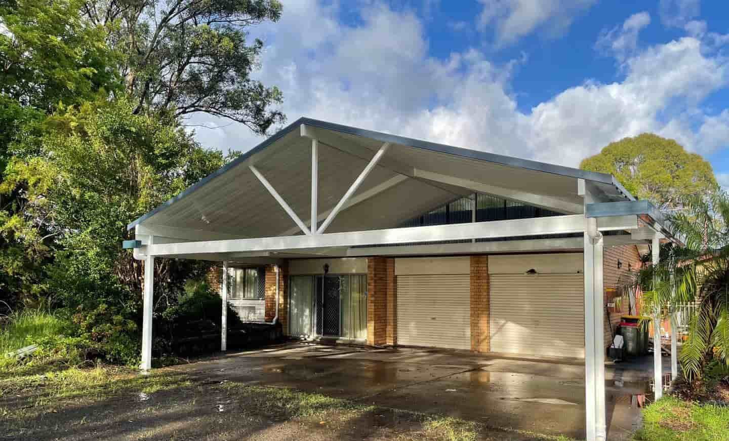 A Carport Is Attached To The Side Of A House — Caprice Home Additions In Port Macquarie, NSW