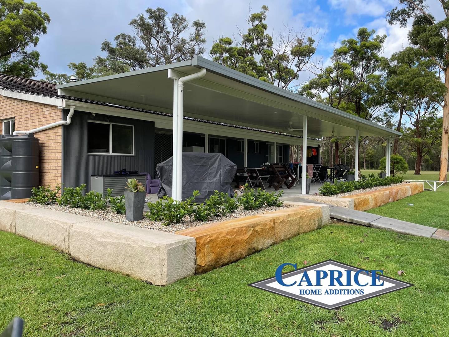 A House With A Patio And A Hot Tub In The Backyard — Caprice Home Additions In Old Bar, NSW