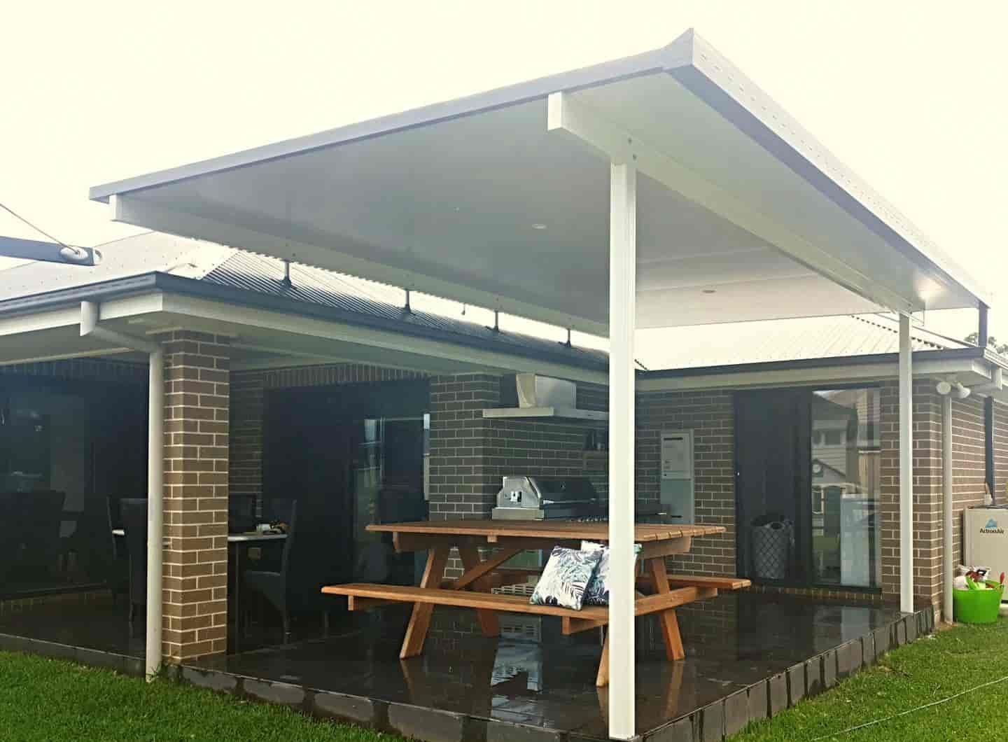 A House With A Covered Porch And A Picnic Table In Front Of It — Caprice Home Additions In Gloucester, NSW