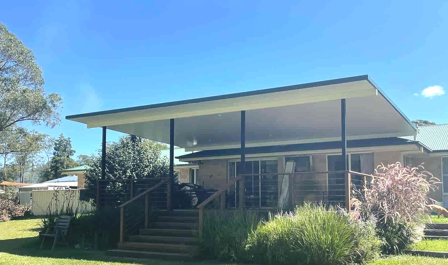 A House With A Covered Porch And Stairs In The Backyard — Caprice Home Additions In Gloucester, NSW