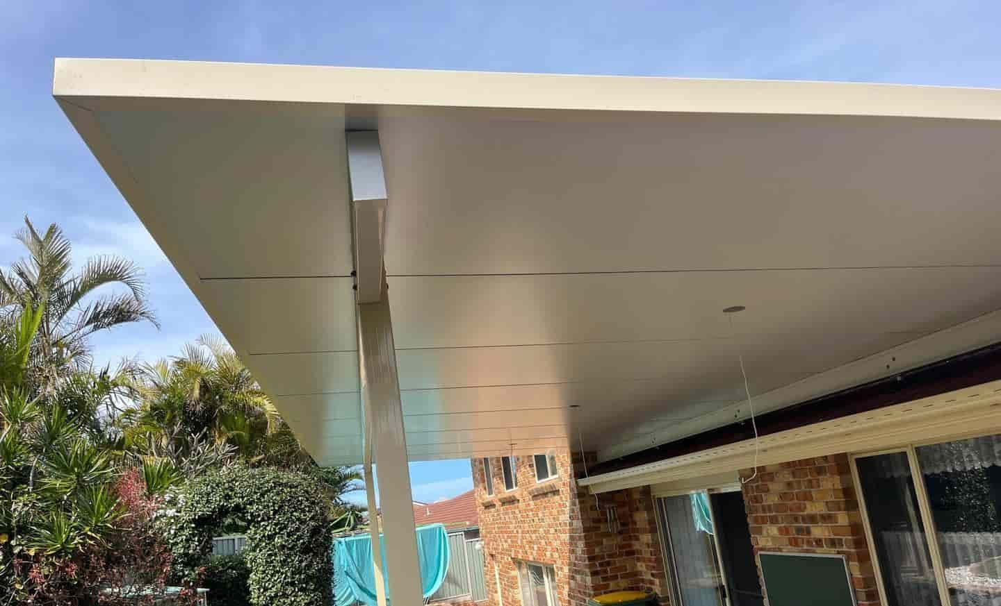 A House With A Covered Patio In Front Of It — Caprice Home Additions In Harrington, NSW