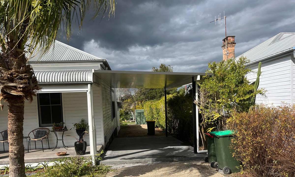 A white house with a carport in front of it.  — Caprice Home Additions In Tuncurry, NSW