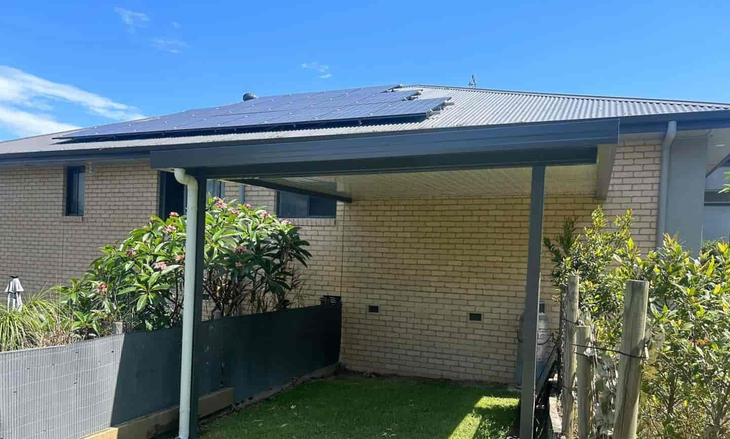 A House With A Covered Area In Front Of It And A Sign In Front Of It — Caprice Home Additions In Old Bar, NSW