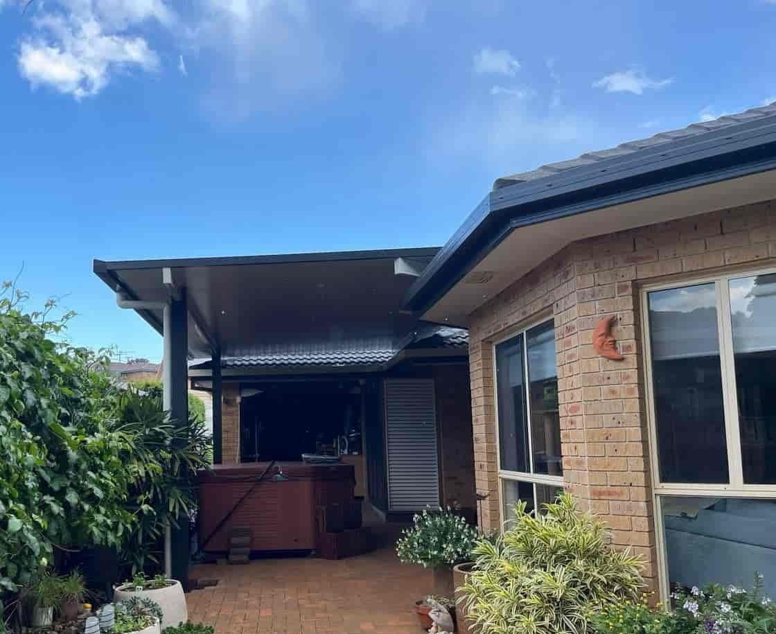 A House With A Patio And A Hot Tub In The Backyard — Caprice Home Additions In Old Bar, NSW