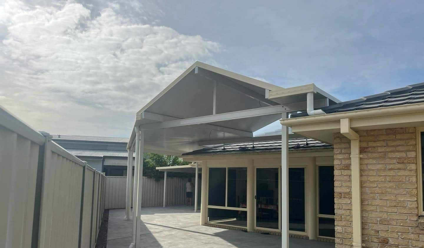 A House With A Carport And A Fence In Front Of It — Caprice Home Additions In Harrington, NSW