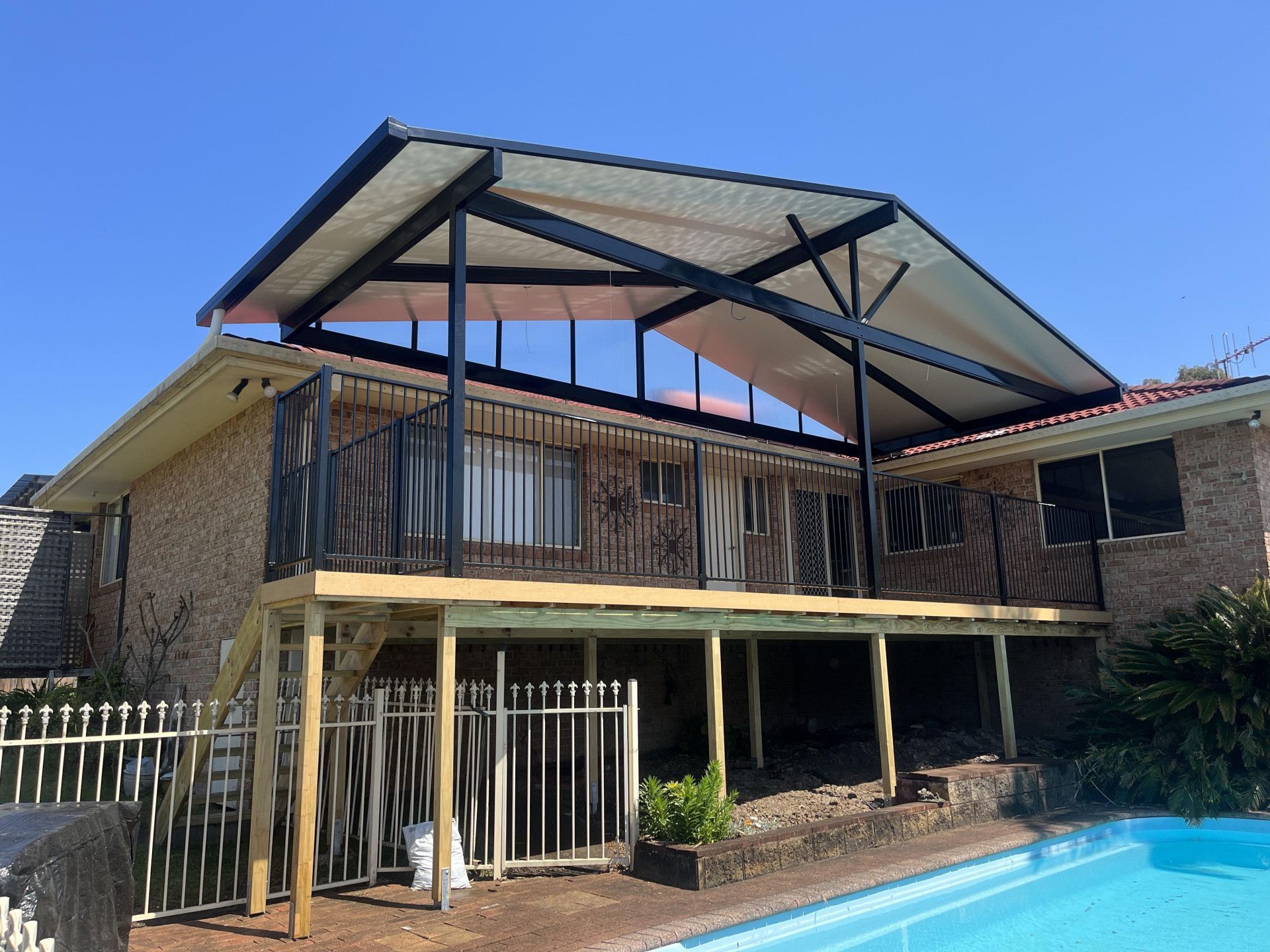 A House With A Wooden Deck And A Covered Porch — Caprice Home Additions In Taree, NSW