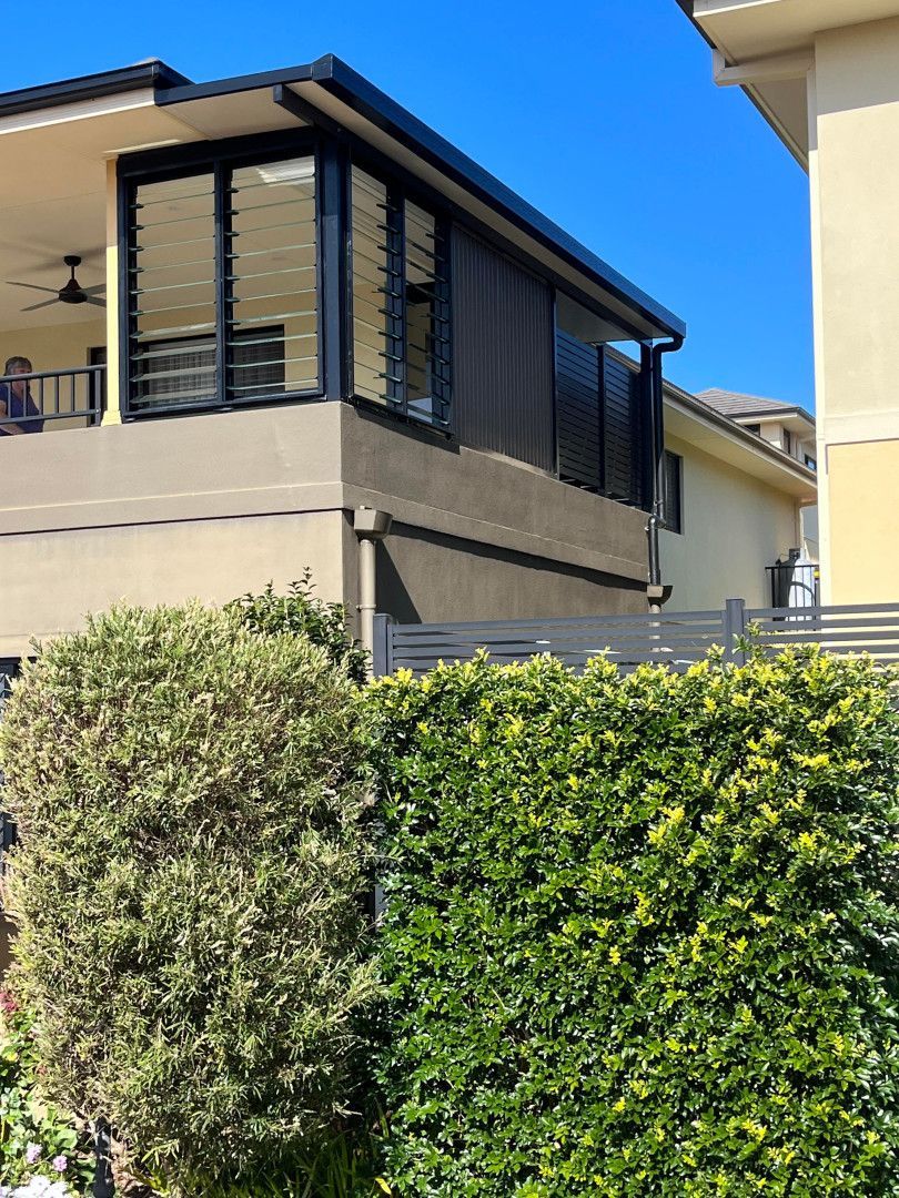 A house with a lot of windows and a fence around it — Caprice Home Additions In Taree, NSW