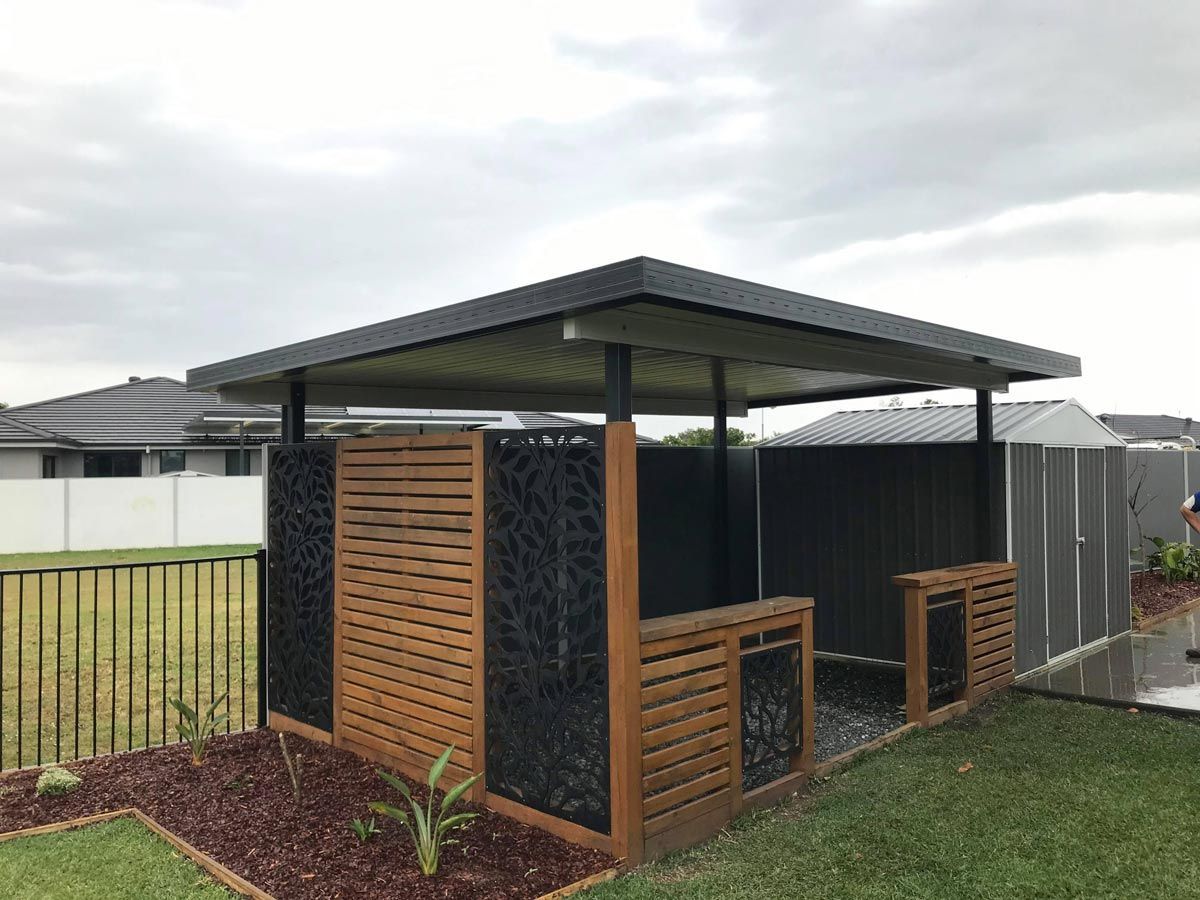 A Wooden Gazebo Is Sitting In The Middle Of A Lush Green Yard — Caprice Home Additions In Port Macquarie, NSW