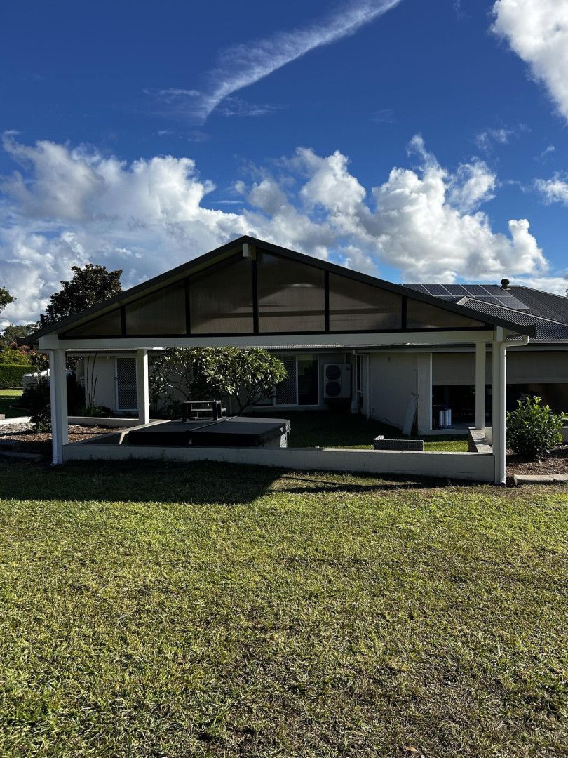 A House With A Screened In Porch And A Large Lawn In Front Of It — Caprice Home Additions In Taree, NSW