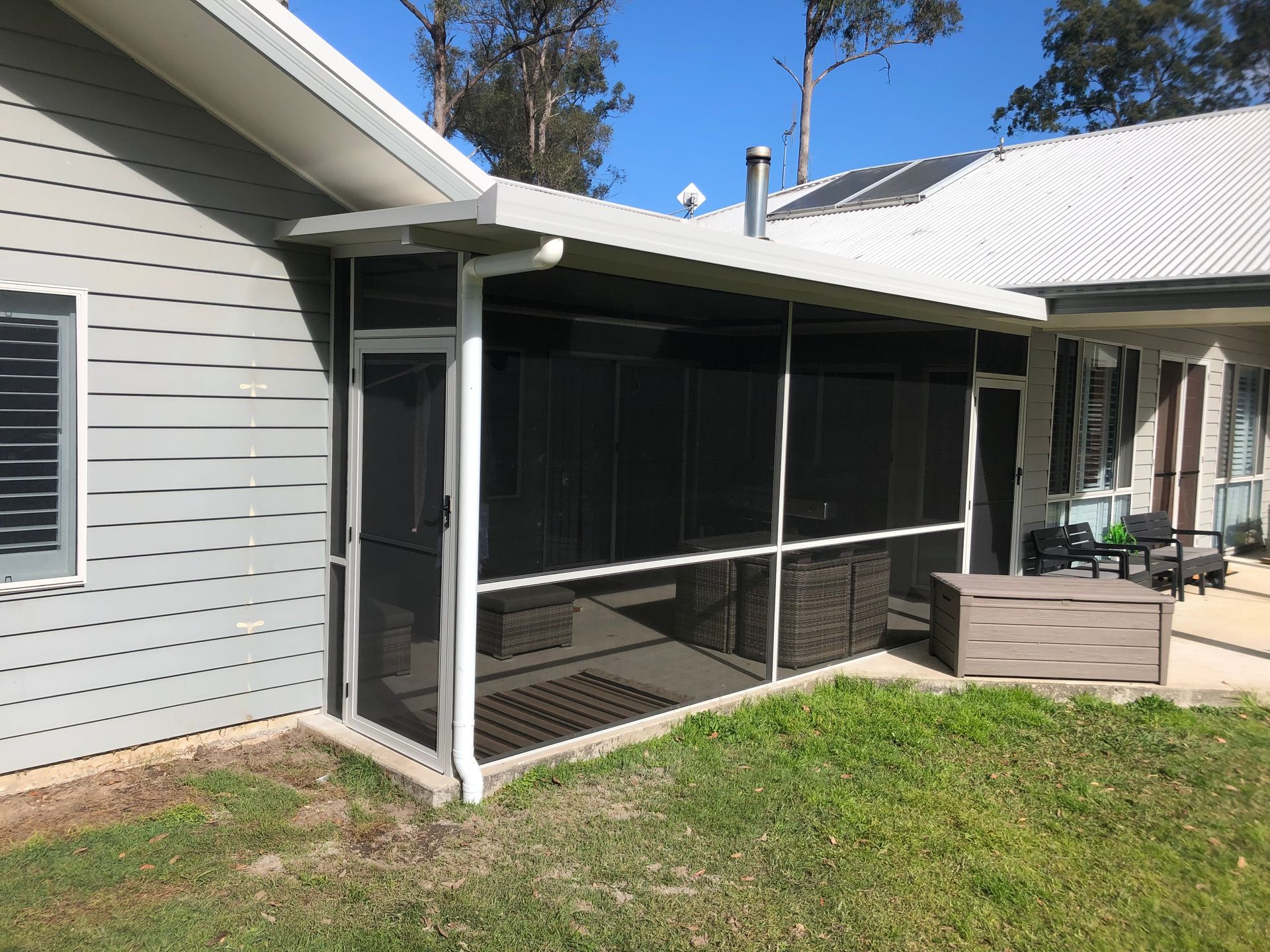 A House With A Screened In Porch And Sliding Glass Doors — Caprice Home Additions In Taree, NSW