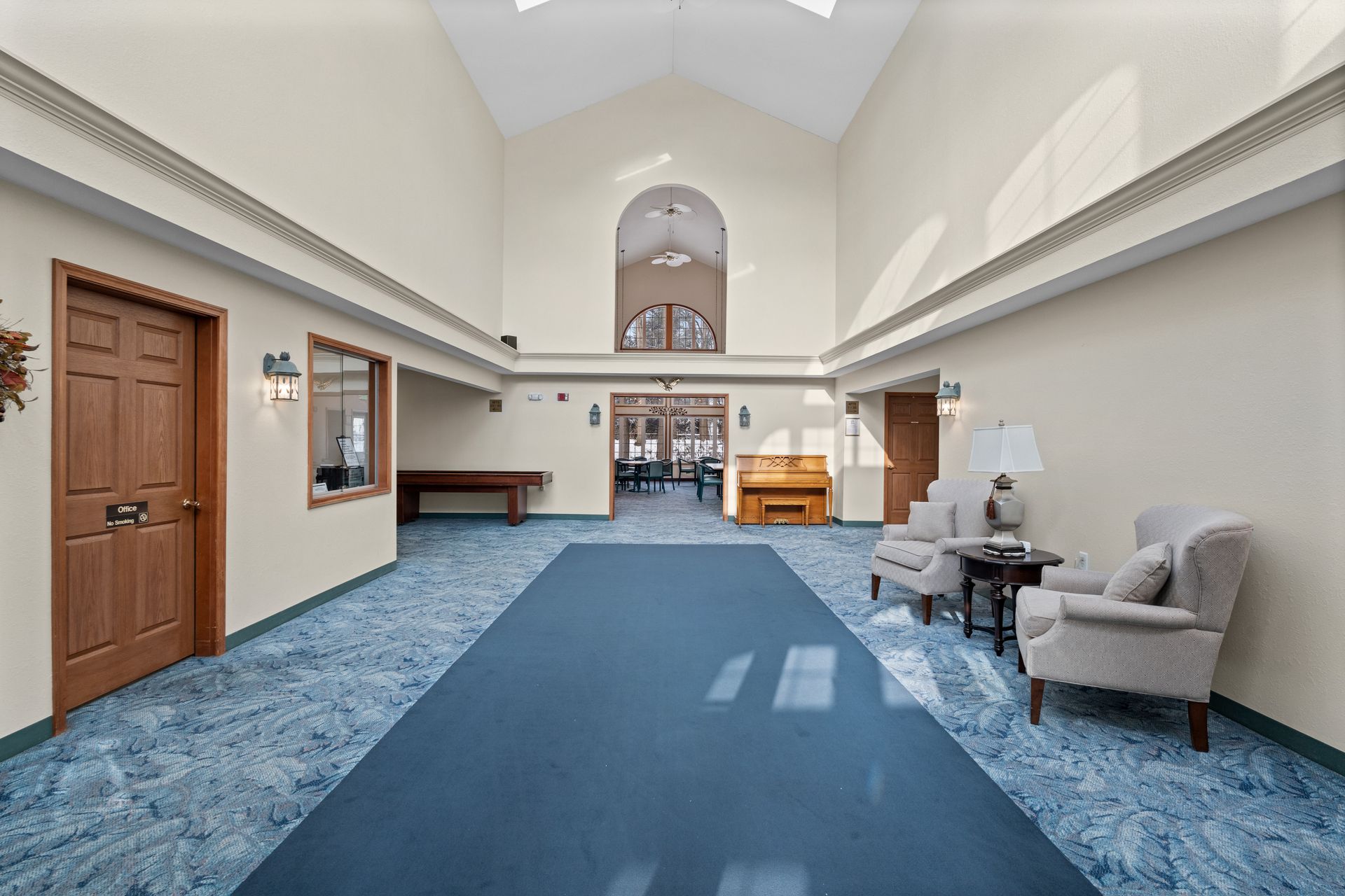 Photo of a great room entrance with plenty of natural lighting, due to the ceiling windows