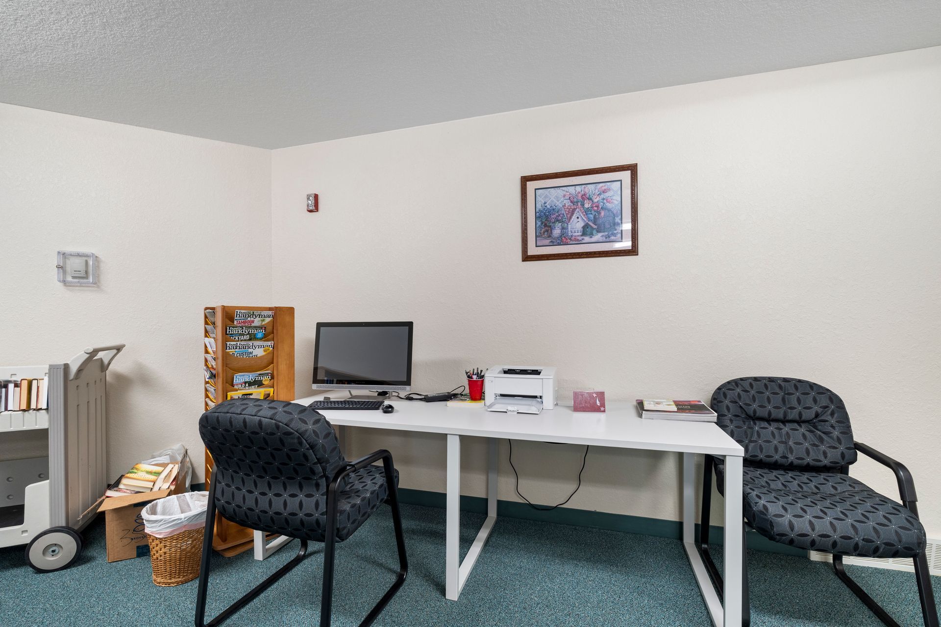 Photo of a desk in the library with a couple of chairs