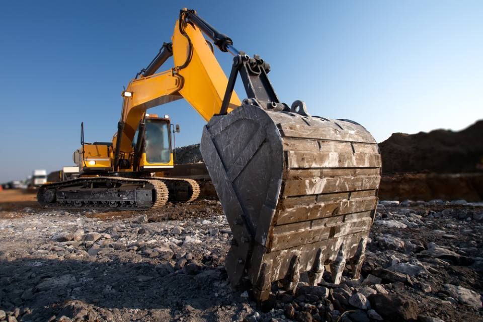 yellow excavators working on a mine