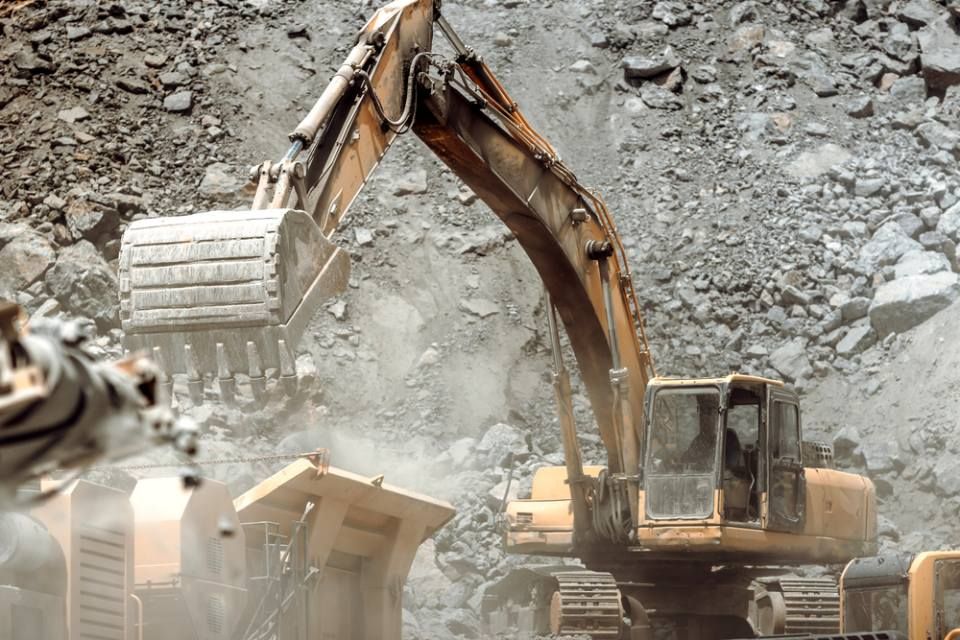 Industrial bulldozer, excavator and track type excavator working on mining site