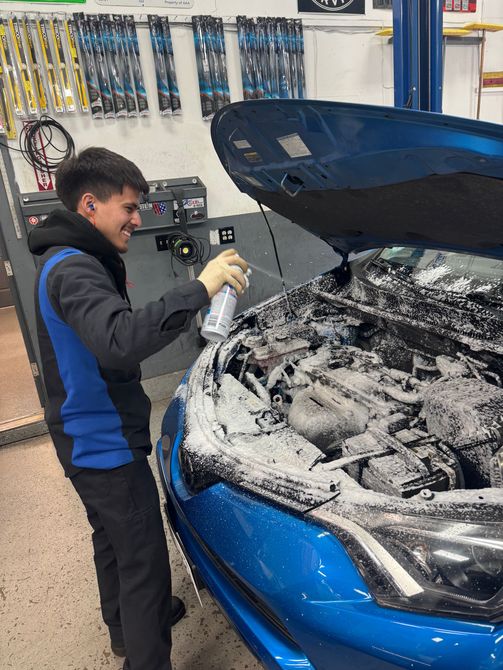 man working on car brake | Mike's Auto Repair