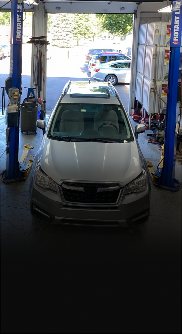 silver suv in garage | Mike's Auto Repair