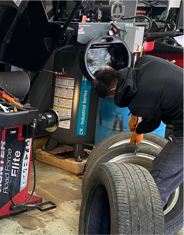 man working on car tire | Mike's Auto Repair